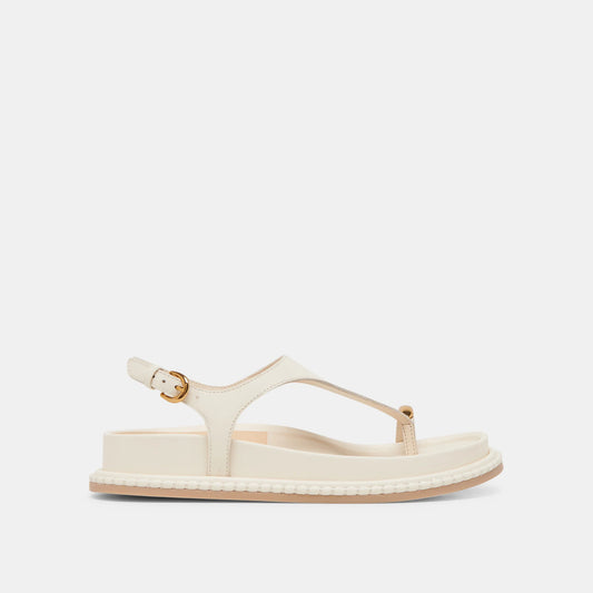 A white sandal with a flat sole, secure straps, and a metal detail on a white background.