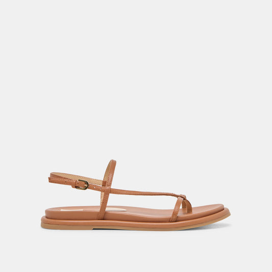 A brown strappy leather sandal with an ankle strap and flat sole.