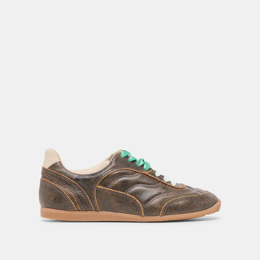 Brown sneaker with green laces on a white background