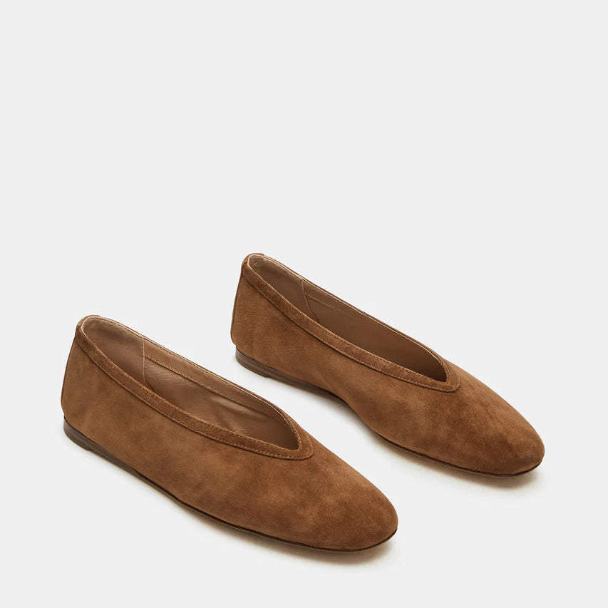 Pair of brown suede flats on a white background